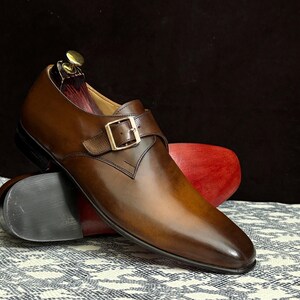 Handmade men's brown single monk strap dress shoes, crafted from premium cowhide leather with Goodyear welt construction, bespoke footwear for timeless style and durability