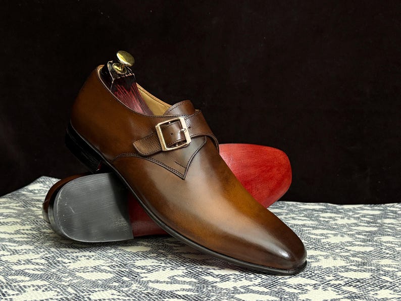 Handmade men's brown single monk strap dress shoes, crafted from premium cowhide leather with Goodyear welt construction, bespoke footwear for timeless style and durability