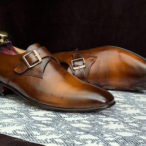 Handmade men's brown single monk strap dress shoes, crafted from premium cowhide leather with Goodyear welt construction, bespoke footwear for timeless style and durability