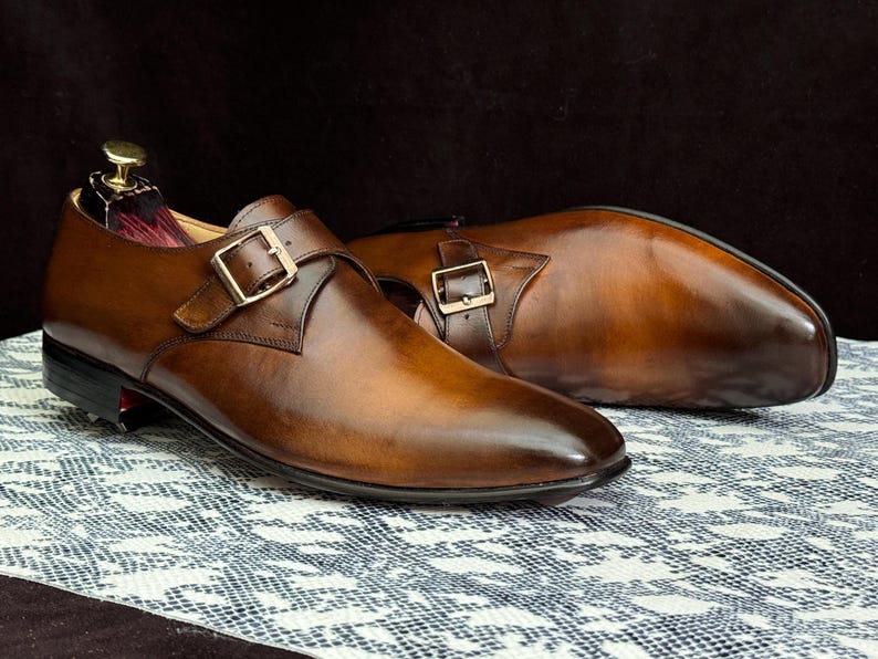 Handmade men's brown single monk strap dress shoes, crafted from premium cowhide leather with Goodyear welt construction, bespoke footwear for timeless style and durability