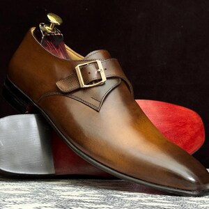 Handmade men's brown single monk strap dress shoes, crafted from premium cowhide leather with Goodyear welt construction, bespoke footwear for timeless style and durability