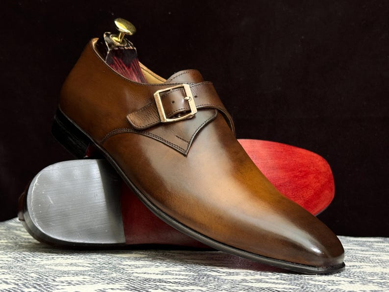 Handmade men's brown single monk strap dress shoes, crafted from premium cowhide leather with Goodyear welt construction, bespoke footwear for timeless style and durability