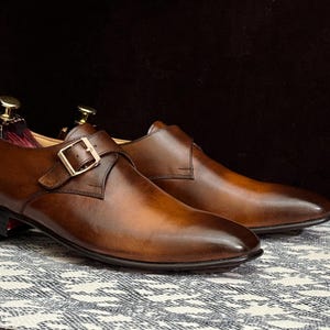 Handmade men's brown single monk strap dress shoes, crafted from premium cowhide leather with Goodyear welt construction, bespoke footwear for timeless style and durability