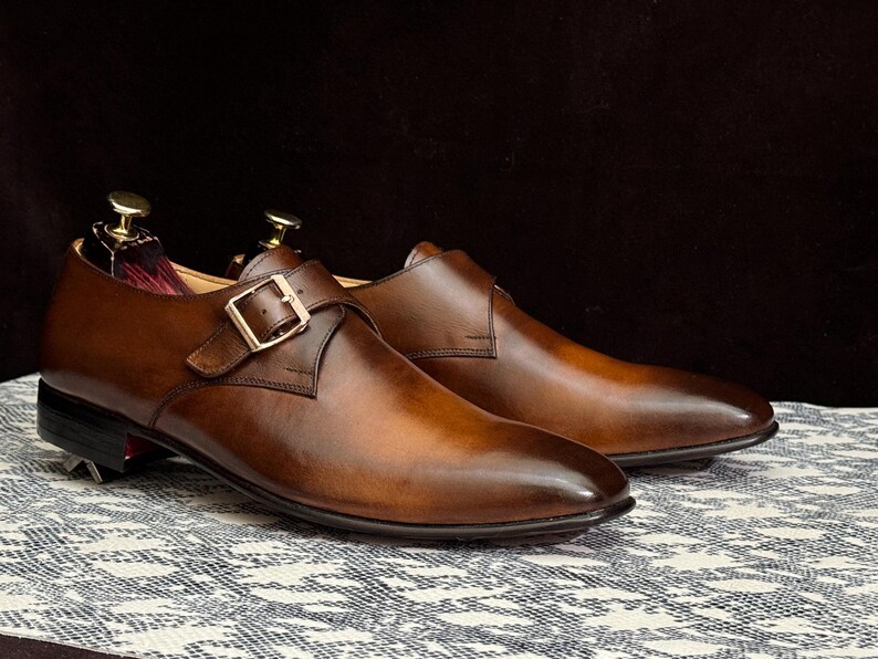 Handmade men's brown single monk strap dress shoes, crafted from premium cowhide leather with Goodyear welt construction, bespoke footwear for timeless style and durability