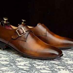 Handmade men's brown single monk strap dress shoes, crafted from premium cowhide leather with Goodyear welt construction, bespoke footwear for timeless style and durability