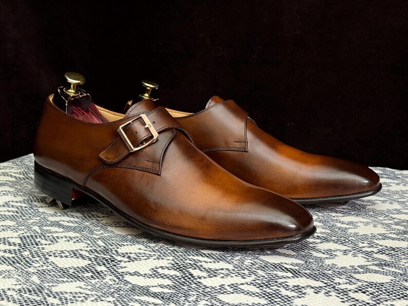 Handmade men's brown single monk strap dress shoes, crafted from premium cowhide leather with Goodyear welt construction, bespoke footwear for timeless style and durability