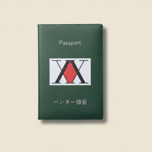 May include: A dark green passport cover with the word "Passport" printed at the top. It features a white rectangle with a red diamond and black "XX" design. Japanese text is printed below the design.