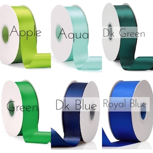 May include: Six spools of ribbon in various colors, including apple green, aqua, dark green, green, dark blue, and royal blue. Each spool has a white label with the color name printed on it.