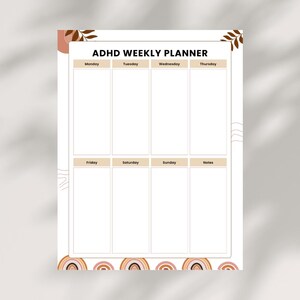 May include: ADHD Weekly Planner with a white background and a minimalist design. The planner features sections for each day of the week, with the days of the week labeled across the top. The bottom of the planner has a rainbow design.