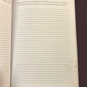 May include: Open notebook page with the heading "Dream & Goal Setting" and the subheading "Long-term goals." The text reads, "Every goal you set is a seed planted in the universe. Nurture your dreams with belief, gratitude and action and watch them bloom into reality."