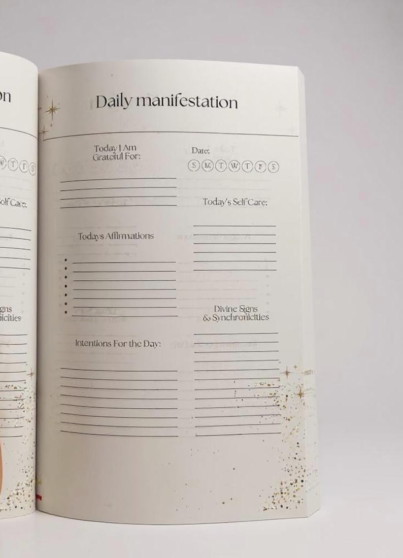May include: Open journal page with the title "Daily manifestation." The page includes prompts for gratitude, self-care, affirmations, and intentions. The date section has circles for each day of the week. Gold glitter accents the page.