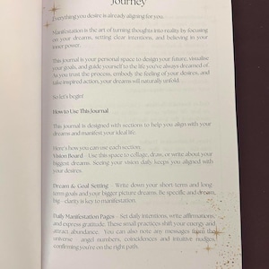 May include: Open journal pages with the title "Welcome To Your Manifestation Journey." The text describes the process of manifestation, setting intentions, and achieving goals. The journal includes sections for vision boards, dream setting, and daily manifestation pages.