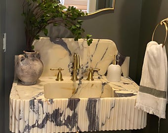 Lavabo in marmo Calacatta Viola, mobile sospeso scanalato per un bagno di lusso.