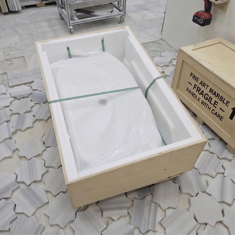 Calacatta Viola handmade stone sink securely placed in protective packaging, showing the basin prepared for safe shipping.