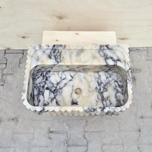 Top view of a Calacatta Viola marble sink showing the spacious basin, rounded inner corners and unique purple and cream natural veining.