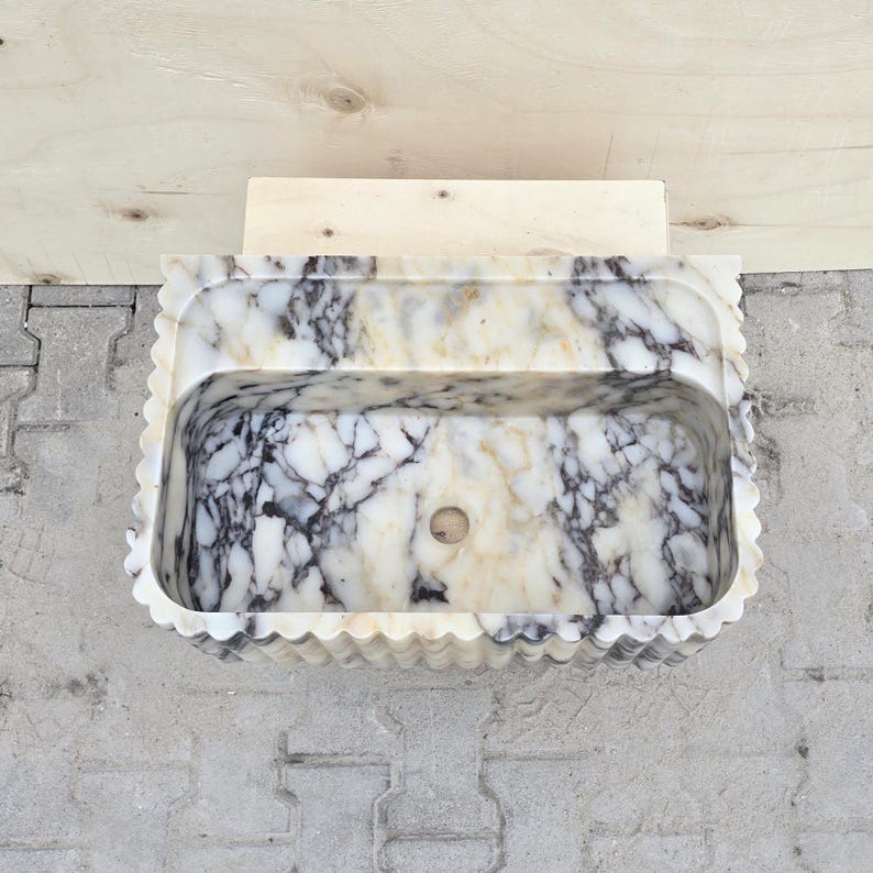 Top view of a Calacatta Viola marble sink showing the spacious basin, rounded inner corners and unique purple and cream natural veining.
