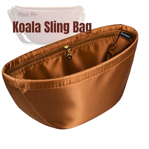 May include: A brown satin bag organizer insert with a zippered top closure and a gold-toned zipper pull. The interior features a small black tag labeled PurzInzert. The text Made For Koala Sling Bag is visible above the insert in the image.
