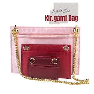 Könnte beinhalten: Eine rosa und rote Stofftasche mit mehreren Taschen und einem goldenen Kettenriemen. Die Tasche trägt den Aufdruck "Made For Kir.gami Bag".