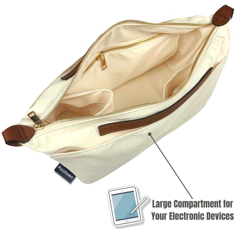May include: Cream-colored shoulder bag with a spacious interior. Features a gold zipper, brown accents, and multiple internal pockets. The bag has a large compartment for electronic devices. The brand name "PurzInzert" is visible on a small tag.
