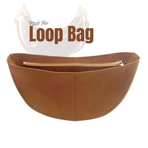 May include: A brown felt Loop Bag organizer with a gold zipper. The text "Made For Loop Bag" is above the organizer. The organizer is designed to fit inside a Loop Bag, providing structure and organization.