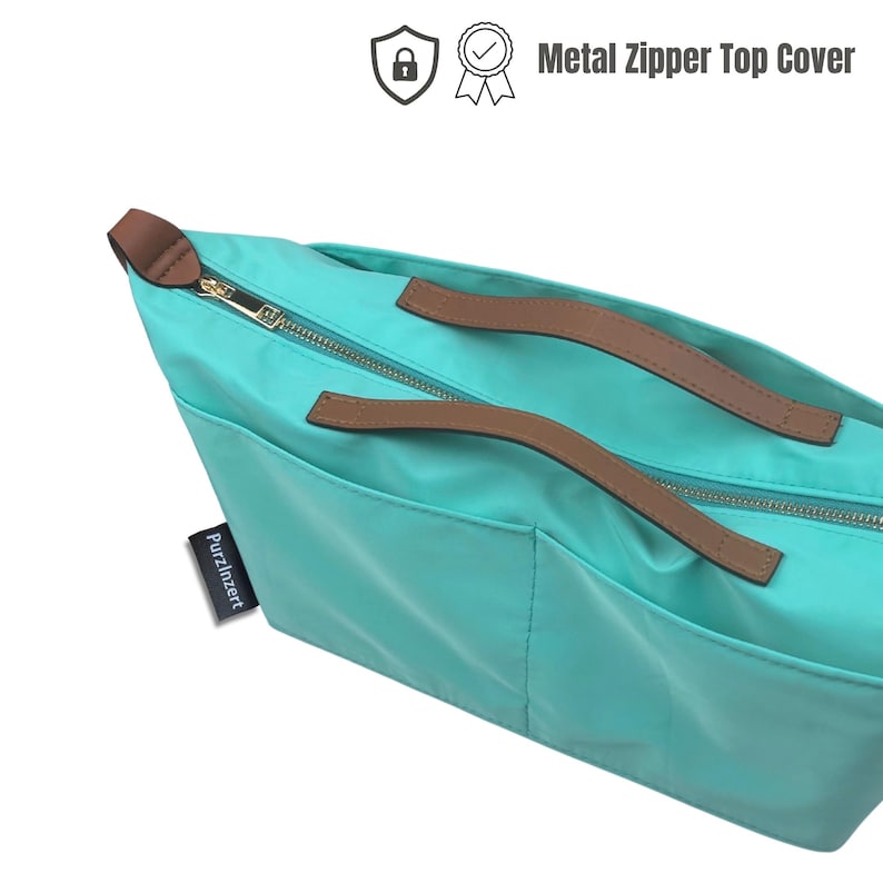 May include: A turquoise tote bag with brown leather handles and a gold metal zipper. The bag has a tag that says "PurzlInzert" and the text "Metal Zipper Top Cover" is visible.