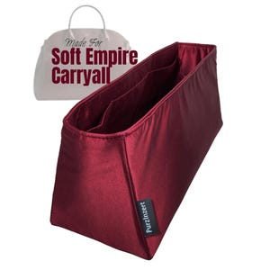May include: A burgundy fabric handbag organizer with multiple compartments. The organizer has a rectangular shape and a label that reads "PurzInzert". The text "Made For Soft Empire Carryall" is in the background.