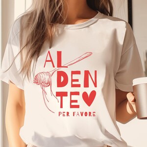May include: White t-shirt with a red graphic that says "Al Dente Per Favore" and a drawing of spaghetti with a fork.