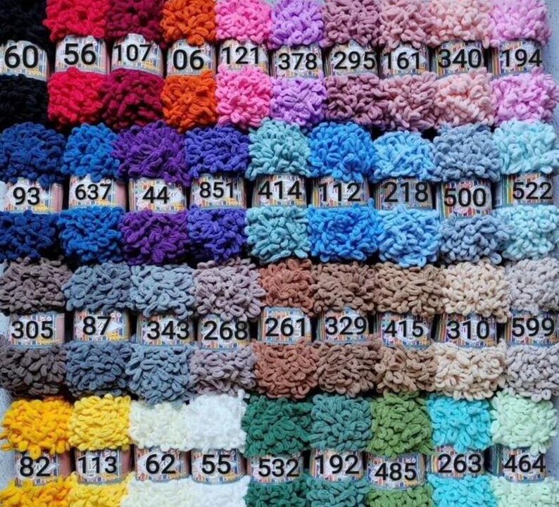 May include: A collection of 40 colorful yarn skeins in various shades of red, pink, blue, green, yellow, orange, purple, brown, and white. Each skein is labeled with a number.