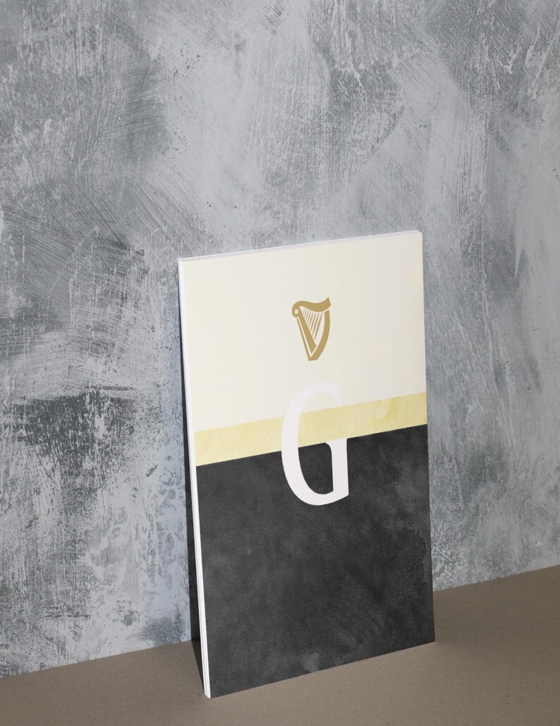 May include: A white and black poster with a gold harp logo and the letter "G" in white. The poster has a textured background.