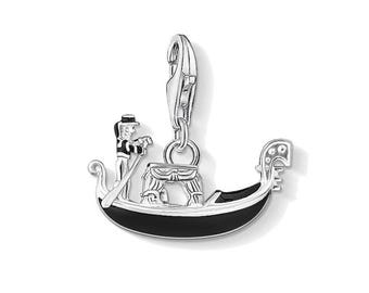May include: Silver charm featuring a black enamel gondola with a gondolier rowing. The charm has a clip-on attachment.