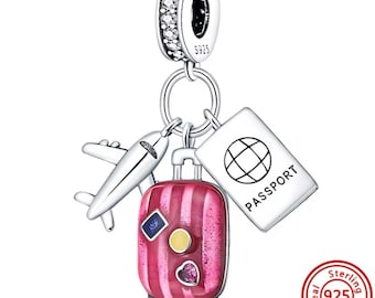 May include: Silver charm with a pink striped suitcase, a small airplane, and a passport with the word "PASSPORT" on it. The charm is made of sterling silver and has a 925 stamp.