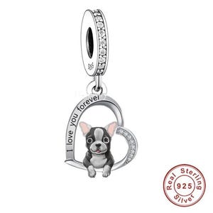 May include: Silver charm with a heart-shaped design featuring a black and white French Bulldog puppy. The heart has the words "I love you forever" inscribed on it. The charm is adorned with clear cubic zirconia stones.