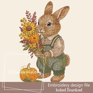 May include: An embroidery design file featuring a charming rabbit holding a bouquet of sunflowers and fall foliage. The rabbit wears green overalls and a sweater. A small pumpkin sits nearby. The text "Embroidery design file Instant Download" is at the bottom.