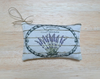 May include: A white fabric pouch with a lavender design. The pouch has a drawstring closure and says "Lavendula Lavender" on the front.