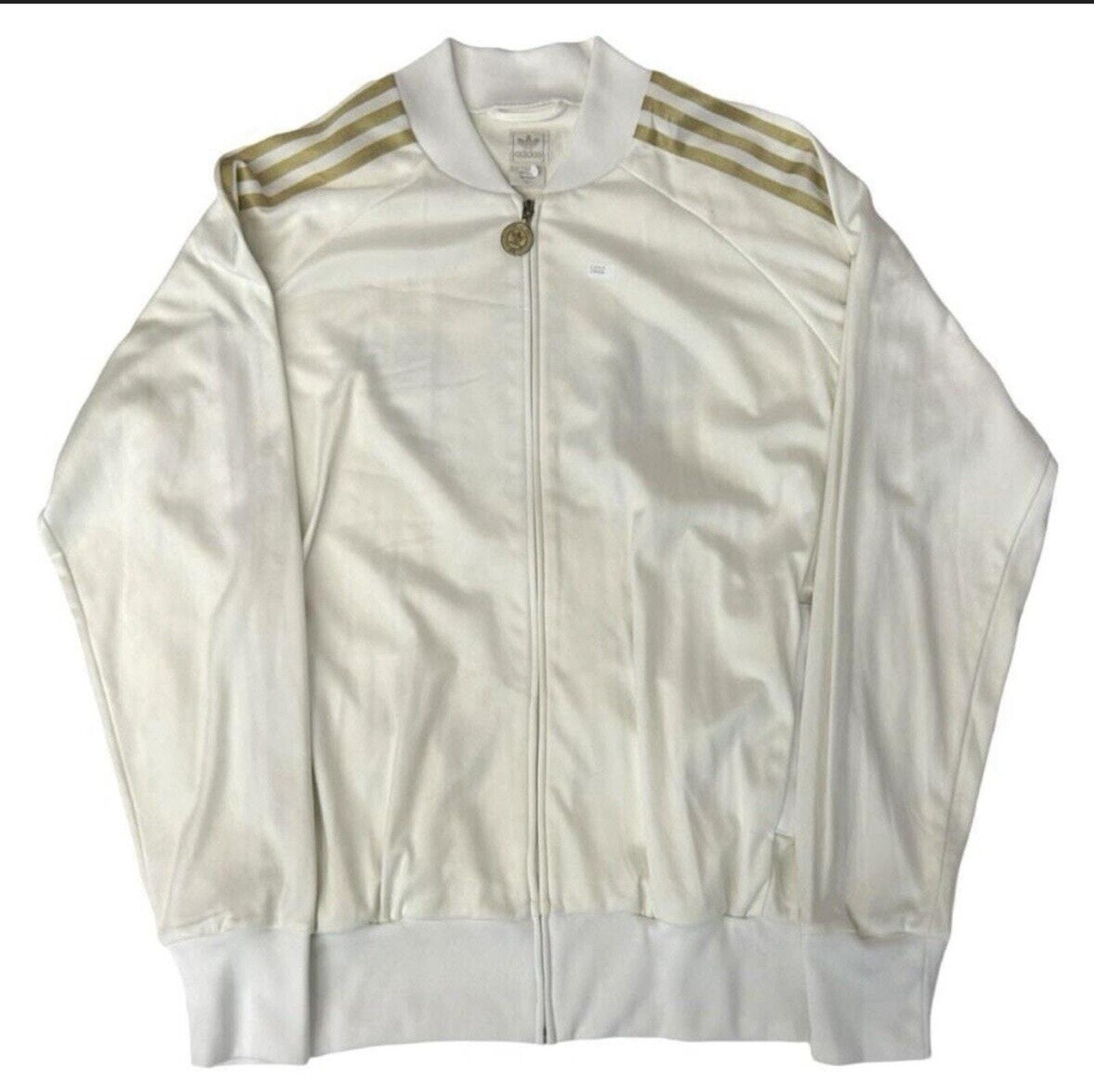 white adidas jacket with gold stripes