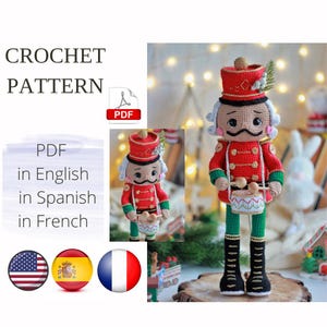 May include: Crochet pattern for a Nutcracker doll. The doll is wearing a red and gold uniform with a green hat and holding a drum. The pattern is available in English, Spanish, and French.