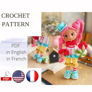 May include: A handmade crochet doll with pink hair, a blue hat, and a red collar. The doll is dressed in a white and red outfit with blue trim and yellow legs. It holds a green and white ball. The image includes the text "CROCHET PATTERN" and "PDF in English in French."