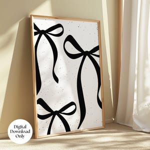 May include: A black and white printable art print featuring three stylized bows with a speckled background.