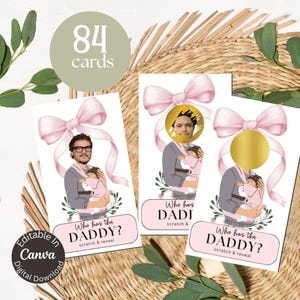 May include: Baby shower game cards with a pink bow and the text "Who has the DADDY?" and "scratch & reveal". The cards feature an illustration of a person holding a baby. The words "Editable in Canva" are also visible.