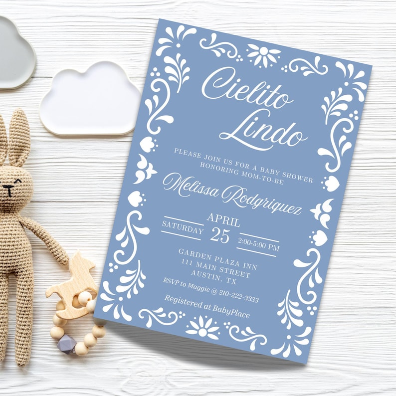 May include: A blue baby shower invitation with a white floral border and the text "Cielito Lindo" in a decorative script font. The invitation includes the date, time, and location of the shower, as well as the name of the honoree, Melissa Rodriguez.