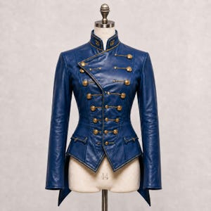 May include: A blue leather jacket with a high collar and gold buttons. The jacket has a tailored fit, with a double-breasted front and decorative gold trim. The jacket is displayed on a mannequin.