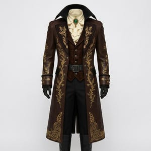 May include: A brown leather coat with gold floral embroidery, a black collar, and a matching vest. The outfit includes a white ruffled shirt, black pants, a belt, and black gloves. A green gem is pinned to the shirt.