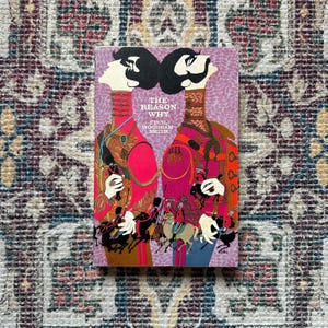 May include: A book cover with a purple background and two men in red and pink uniforms. The title of the book is "The Reason Why" by Cecil Woodham-Smith.