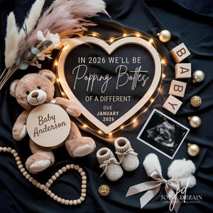 May include: A pregnancy announcement with a teddy bear, baby shoes, and a heart-shaped frame with the text "In 2026 We'll Be Popping Bottles Of A Different Due January 2026". Includes wooden blocks spelling "BABY".