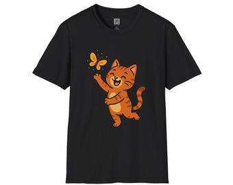 May include: Black t-shirt featuring a cartoon orange tabby cat reaching for a yellow butterfly. The cat has brown stripes and a happy expression. The butterfly has yellow and orange accents. The shirt is made of a soft material.
