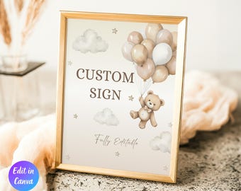 May include: A framed sign with a gold border features a teddy bear holding balloons. The sign reads "CUSTOM SIGN" and "Fully Editable" in a soft, neutral color palette. Clouds and stars decorate the background. The words "Edit in Canva" are in a purple circle.