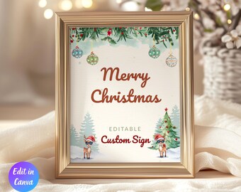 May include: A framed Christmas sign with a gold-colored frame. The sign features the text "Merry Christmas" in a festive font, along with illustrations of Christmas trees, reindeer, and ornaments. The words "Editable Custom Sign" are also displayed.