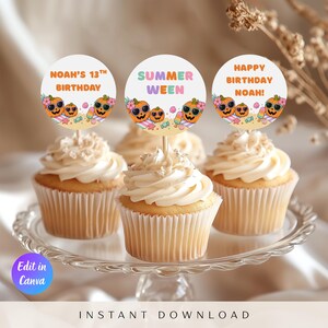 May include: Three vanilla cupcakes with white frosting on a glass stand, each topped with a circular paper topper. The toppers feature orange jack-o'-lanterns wearing sunglasses, beach items, and text reading Noah's 13th Birthday, Summer Ween, and Happy Birthday Noah!