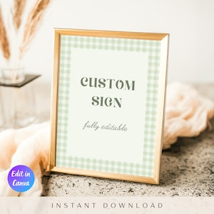 May include: A framed sign with a gold border, featuring a light green gingham pattern around the edges. The sign reads "CUSTOM SIGN" and "fully editable" in a simple font. The words "Edit in Canva" and "INSTANT DOWNLOAD" are also visible.