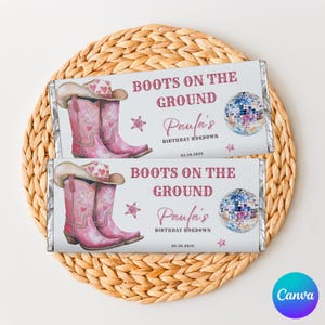 May include: Two candy bar wrappers with a pink cowboy boot and hat design. The wrappers have the text "BOOTS ON THE GROUND" and "Paula's BIRTHDAY HOEDOWN". A disco ball and stars are also featured.